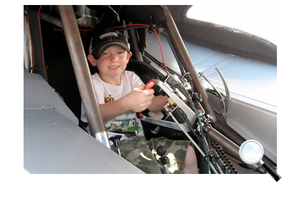 This young guy, Jackson, is getting a lesson in driving a funny car